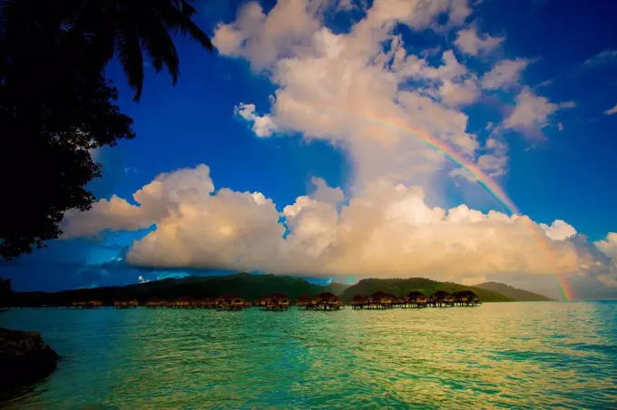 Rainbow arcing over the overwater bungalows, Le Taha'a Resort, Tahiti, French Polynesia, South Pacific, Pacific
