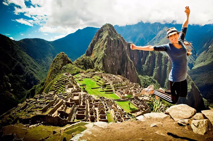 Laura Grier jumping at Machu Picchu ruins, Peru, South America