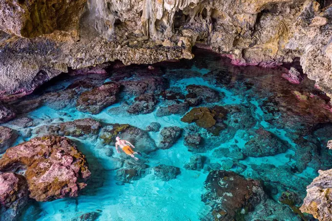 Tourists swimming in the amazing Avaiki rock tide pools Niue, South Pacific, Pacific