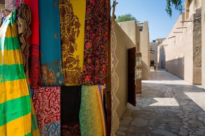 Narrow street and fabric shop in Al Fahidi Historical Centre, Bur Dubai, Dubai, United Arab Emirates, Middle East