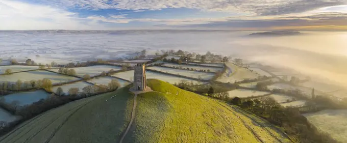 Aerial view by drone of frosty winter morning at Glastonbury Tor, Somerset, England, United Kingdom, Europe