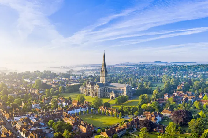Aerial view over Salisbury and Salisbury Cathedral on a misty summer morning, Salisbury, Wiltshire, England, United Kingdom, Europe