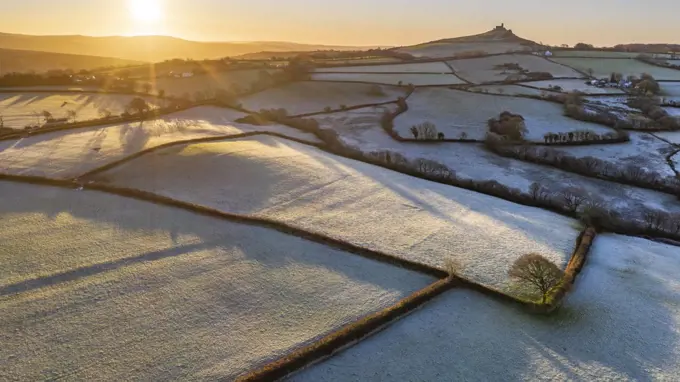 View by drone of frosty winter sunrise over Dartmoor countryside near Brentor, Devon, England, United Kingdom, Europe