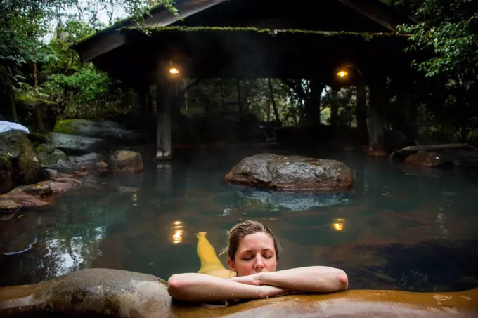 Woman enjoying the hot waters of the Kurokawa onsen, public spa, Kyushu, Japan, Asia