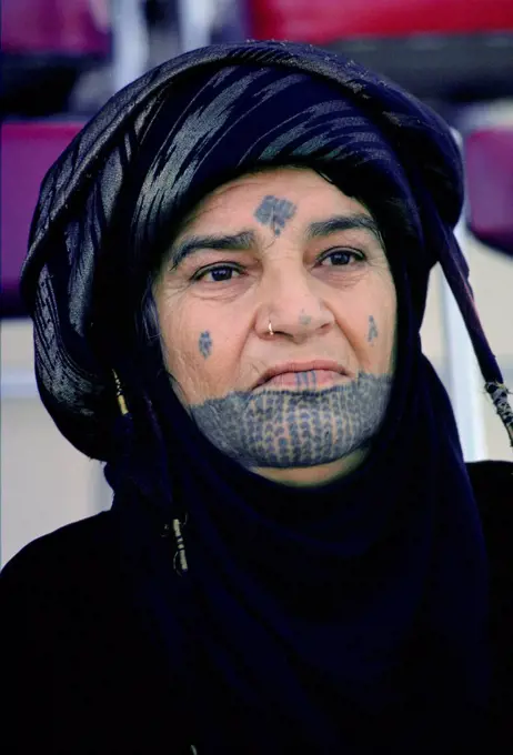 Woman with traditional tatooed markings on her face, Qatar