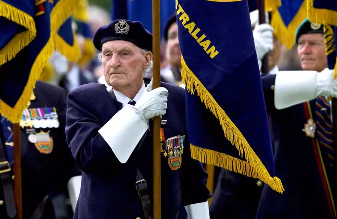 Veterans of the D-Day Landings with their flags in a parade at the start of the 60th Anniversary Commemorations.