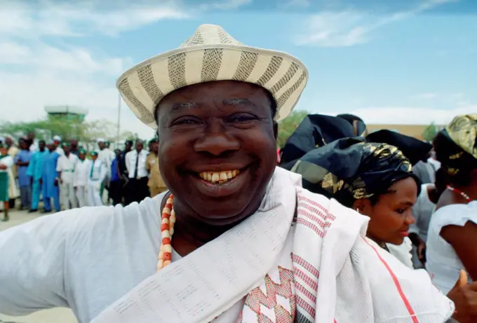 A happyl, smiling Nigerian man waiting for friends at Maiduguri Airport in Nigeria