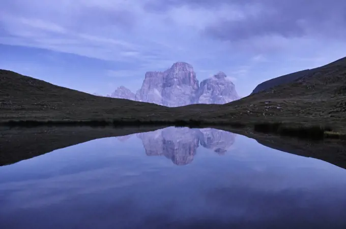 Reflection of Pelmo mountain in the Baste lake during blue hour, Dolomites, Trentino-Alto Adige, Italy, Europe