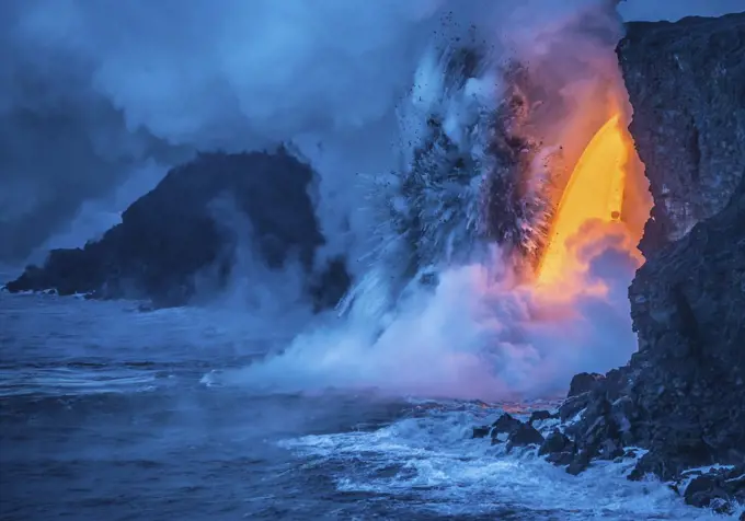 A Lava fall pours from a lava tube 60 feet high, the heat and pressure of super heated ocean steam creates powerful explosions, Hawaii Volcanoes National Park, UNESCO World Heritage Site, Hawaii, United States of America, Pacific