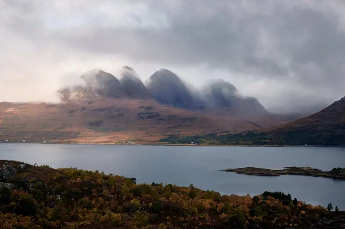 Mountains in the mist facing a lake in the Scottish Highlands, Scotland, United Kingdom, Europe