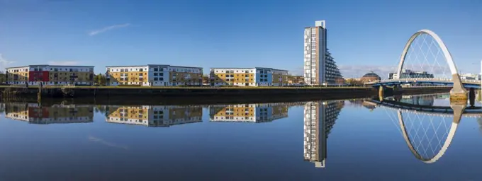Panoramic reflection of Clyde Arc (Squinty Bridge) and flats, River Clyde, Glasgow, Scotland, United Kingdom, Europe