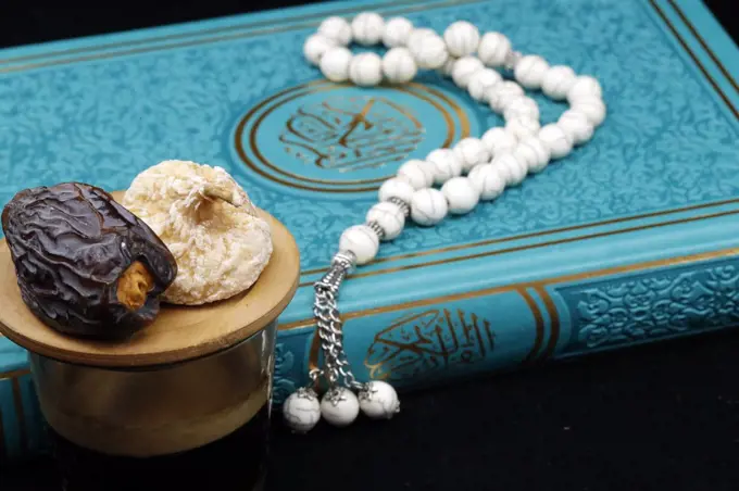 Holy Quran book with prayer beads and date, Ramadan concept, Muslim faith and religion, France, Europe