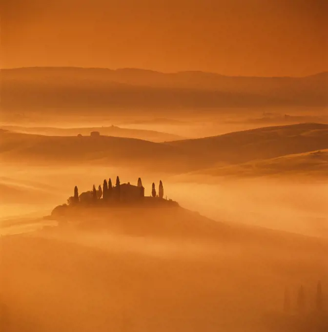 Tuscan farmhouse with cypress trees in misty landscape at sunrise, San Quirico d'Orcia, Siena Province, Tuscany, Italy, Europe