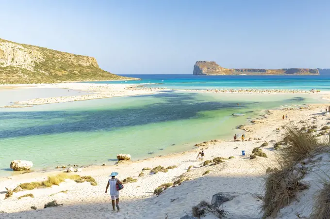 Tourists walking to the white sand beach surrounding Balos lagoon, Crete, Greek Islands, Greece, Europe