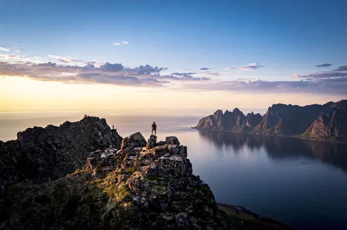 Person contemplating sunset from top of mountains, Senja island, Troms county, Norway, Scandinavia, Europe
