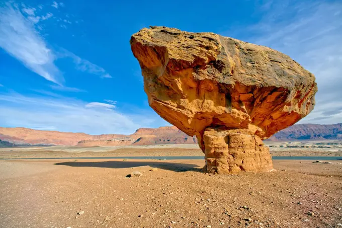 Balanced boulder at the base of Vermilion Cliffs in Glen Canyon Recreation Area, Arizona, United States of America, North America
