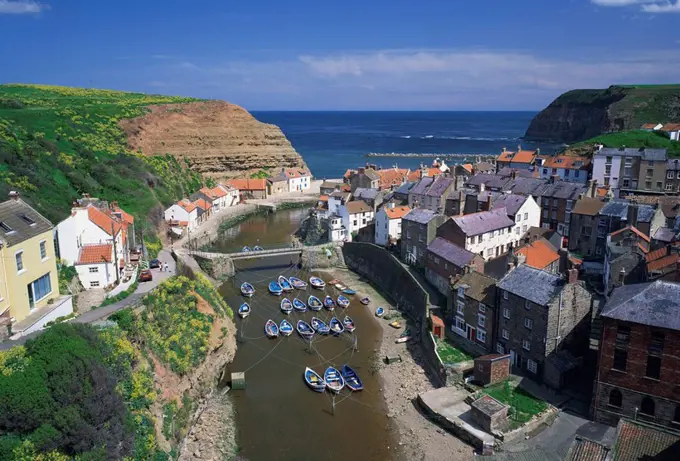 Boats moored in the protected harbour of Staithes, Yorkshire, England, United Kingdom, Europe