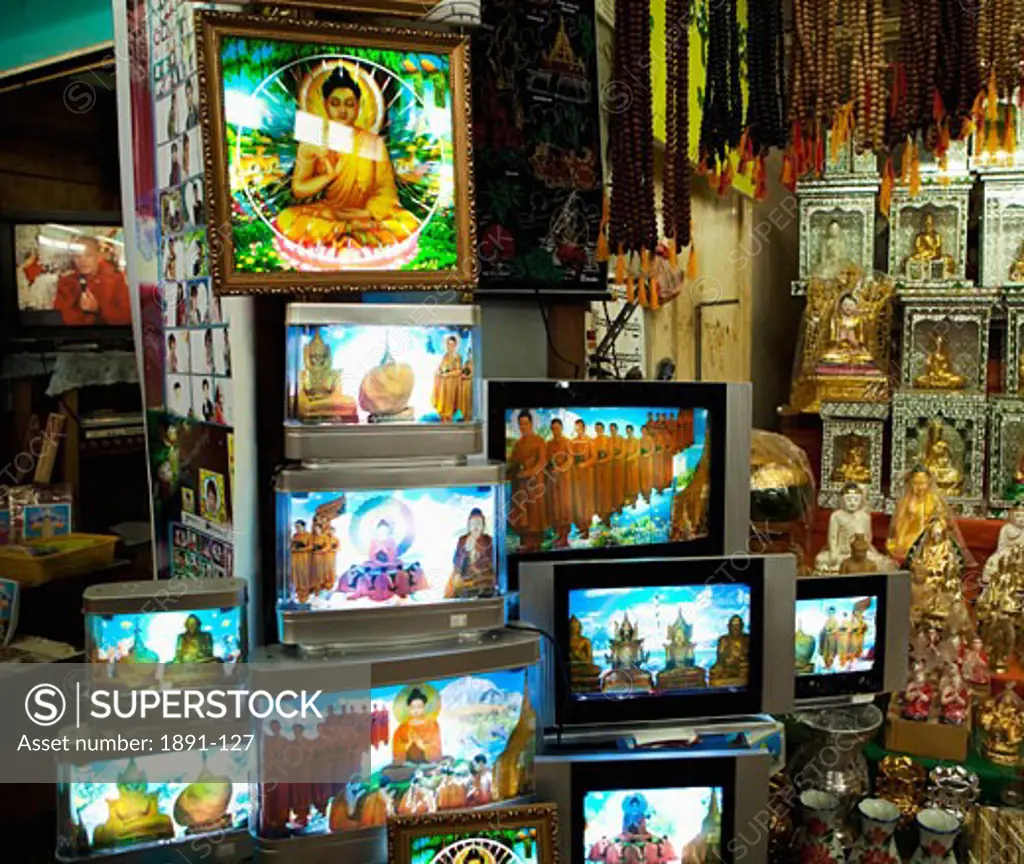 Statues and picture frames of Buddha's at a market stall, Myanmar
