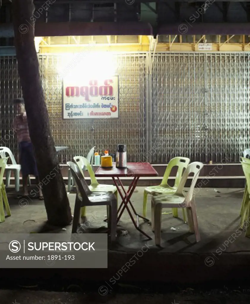 Empty chairs in a sidewalk cafe, Myanmar