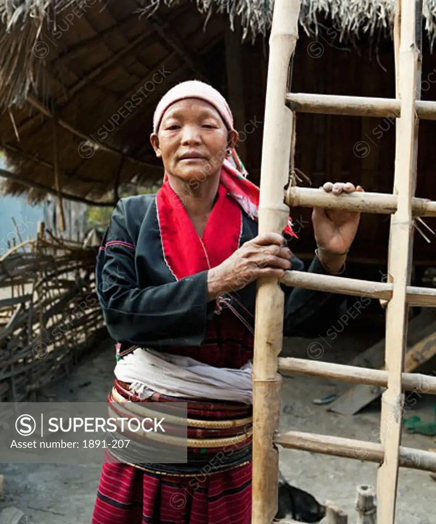 Ang woman standing with a ladder, Myanmar