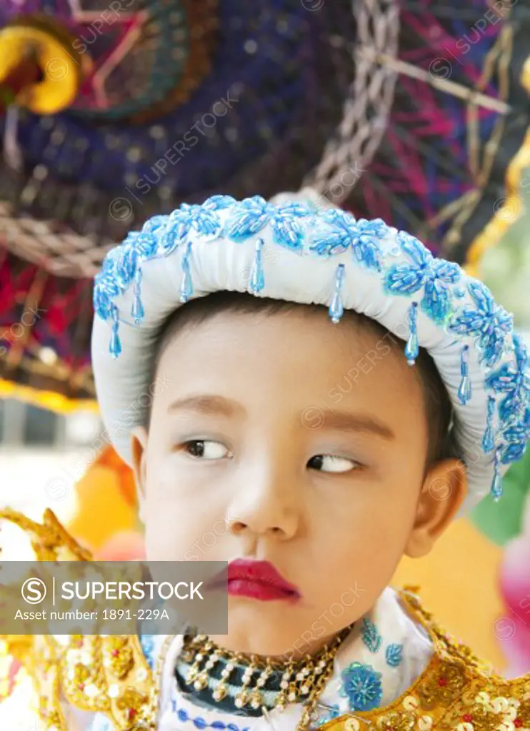 Close-up of a boy dressed up for a ceremony, Myanmar
