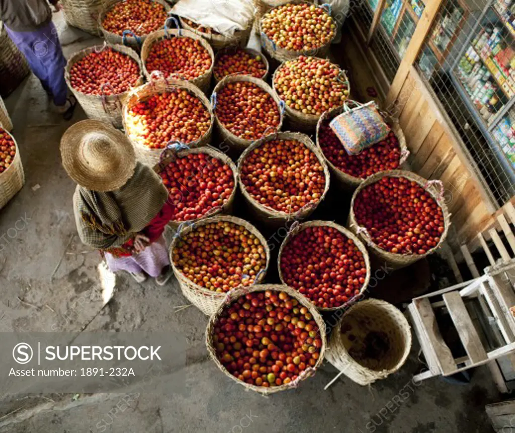 Baskets of tomatoes in a street market, Myanmar
