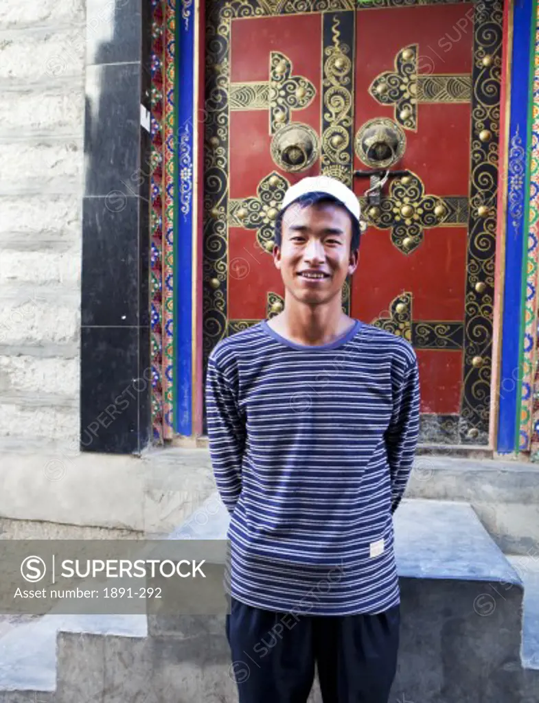 Man standing in front of a closed door, Tibet