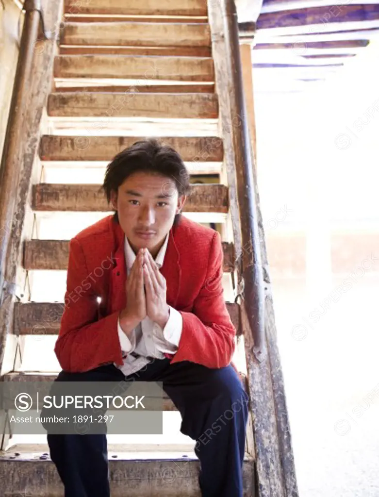 Man sitting on steps, Tibet