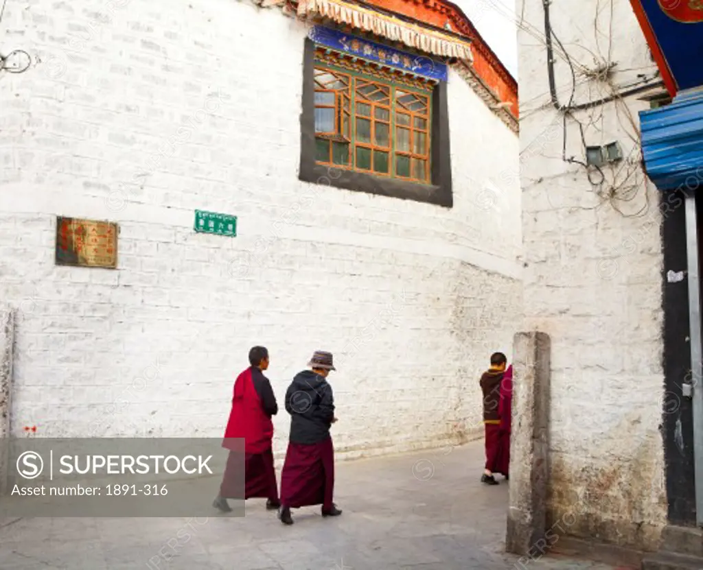 Monks walking through street, Lhasa, Tibet,