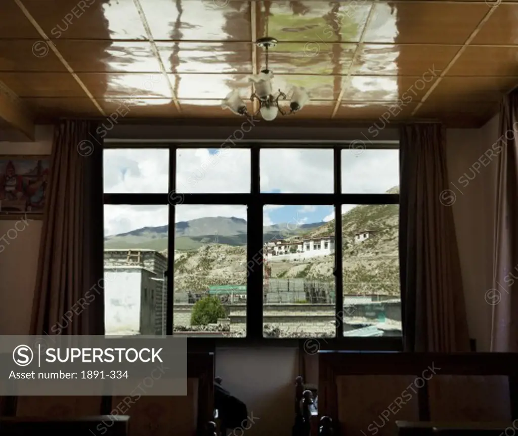 Temple viewed through the window of a dining hall, Tibet,