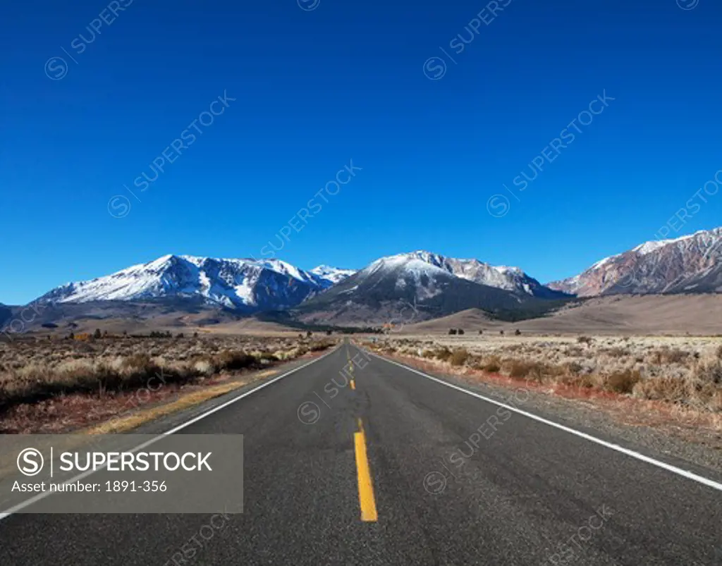Road leading towards a mountain range