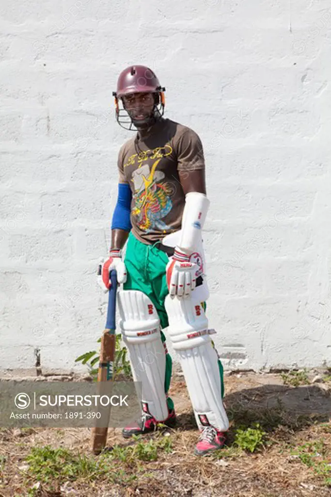 Cricket batsman standing in front of a wall, Jamaica