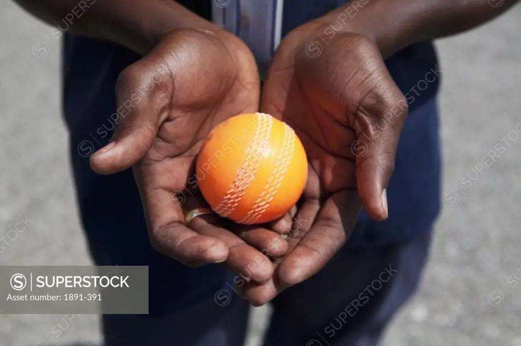 Close-up of a person's hands holding a cricket ball, Jamaica