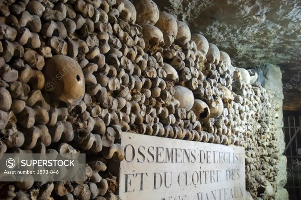 Human skulls lining the walls of the ancient Catacombs in Paris, Ile-de-France, France