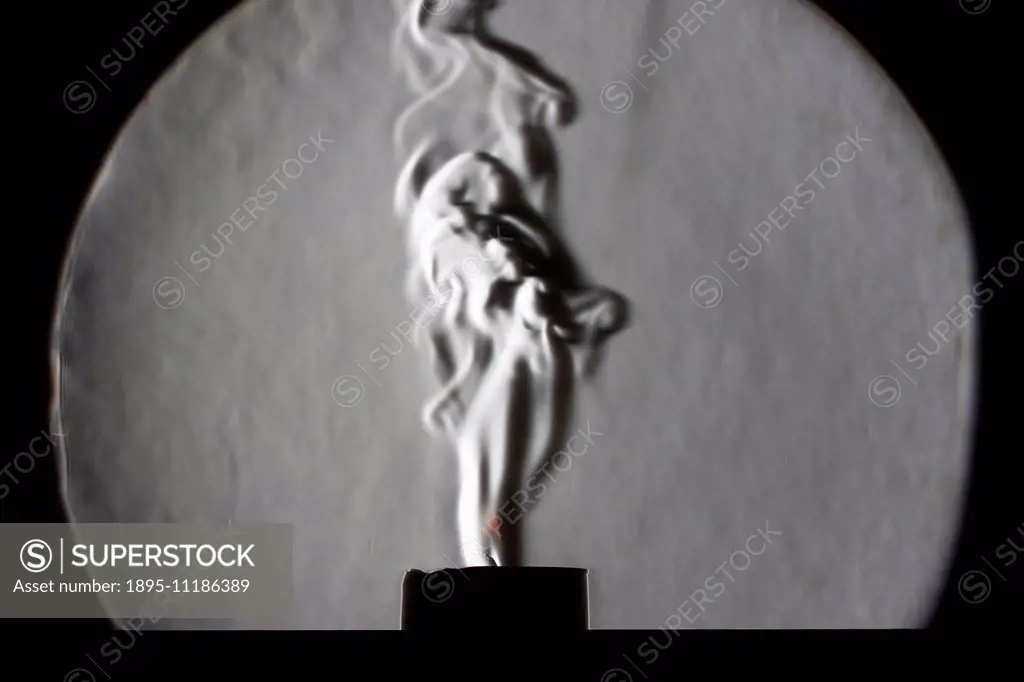 Candle imaged in schlieren set up. A photograph of a candle placed in a schlieren set up. The image reveals the change in heat in the atmosphere cause...