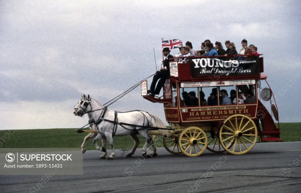Photograph taken in the 1980s of a horse-drawn London omnibus loaded with passengers on an open day at the Science Museums Wroughton Airfield, Wiltsh...