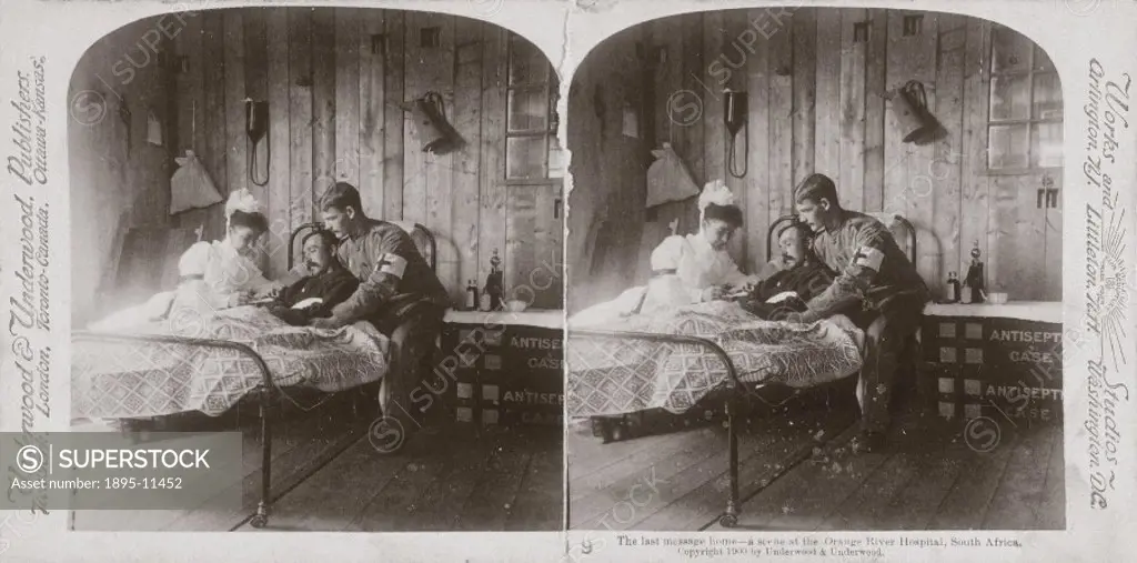A nurse and orderly tend a patient. The bedside table has been made from used antiseptic cases. One of a boxed set of stereoscope photographs produced...