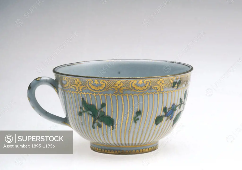 Small porcelain teacup, with printed flowers and gilt decoration. It is marked with the blue cross used at Cookworthy´s and Champion´s Bristol factory...