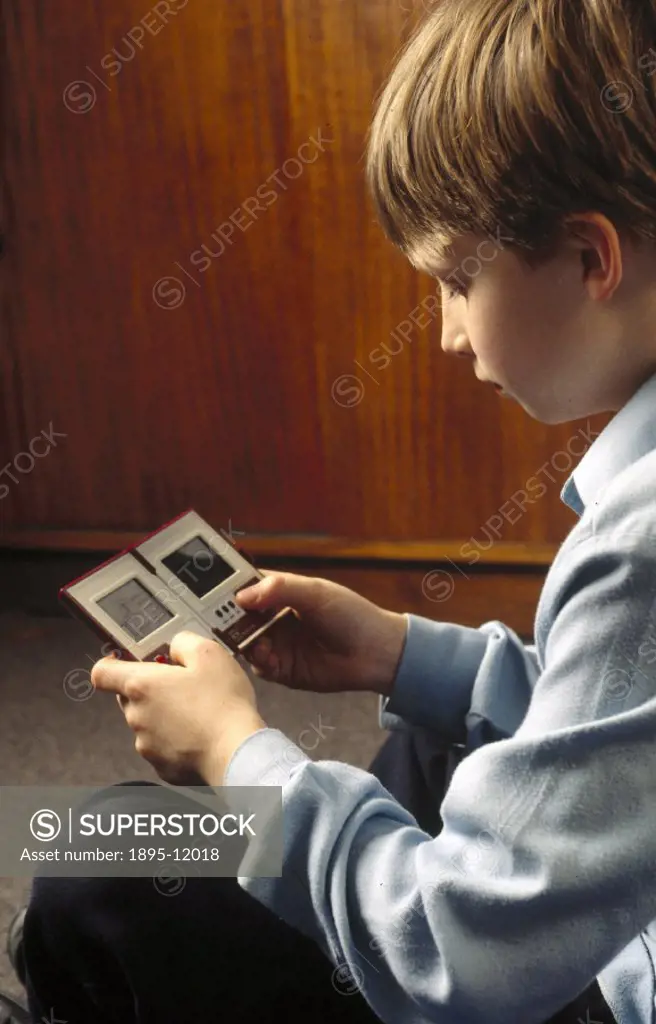 Gabriel Bailey, aged 11, playing ´Mario Bros´ on a Nintendo hand-held computer.