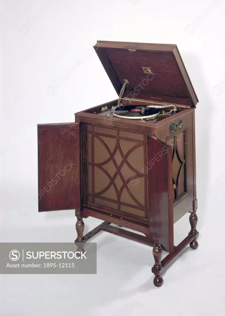 This floor-standing gramophone, model 163, was produced by HMV at the height of the dance band era. The gramophone had been invented by the German-Ame...