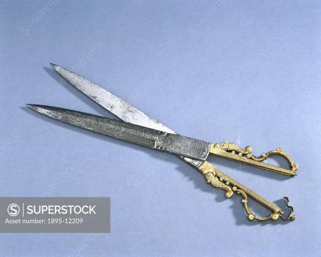 These scissors are made of steel with gilt brass handles and are in the form of a dagger. They are a very elaborate exhibition piece made by J Moseley...
