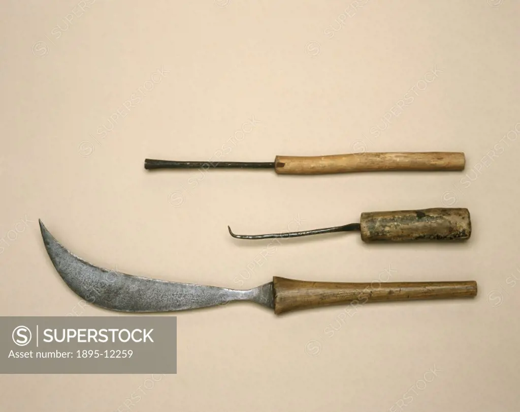 The curved knife (bottom) was collected by Dr Robert Felkin, who witnessed it being used during a Caesarean section in Uganda, Central Africa. The two...