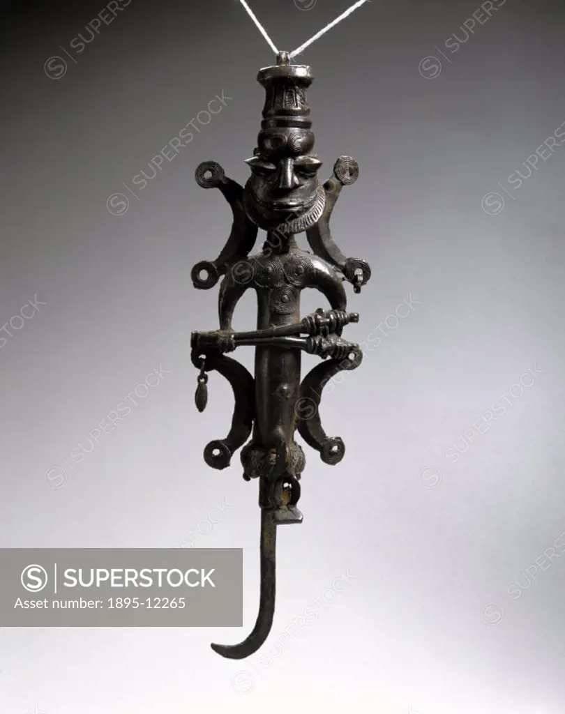 This staff is an Ogboni sceptre. It has a hooked grip,a loop on top of the head, and a male figure holding a pair of figurated spikes. The Ogboni (Osu...