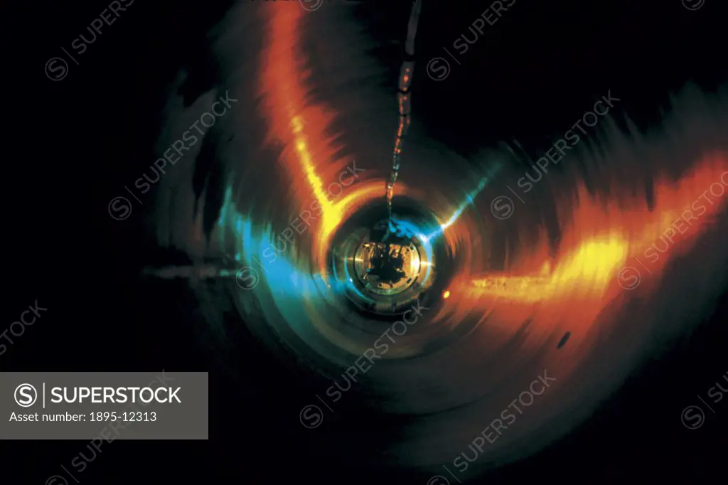 Artists impression of a superconducting magnet for LHC (Large Hadron Collider) being lowered into its cryostat. LHC is a proton-proton collider, due ...