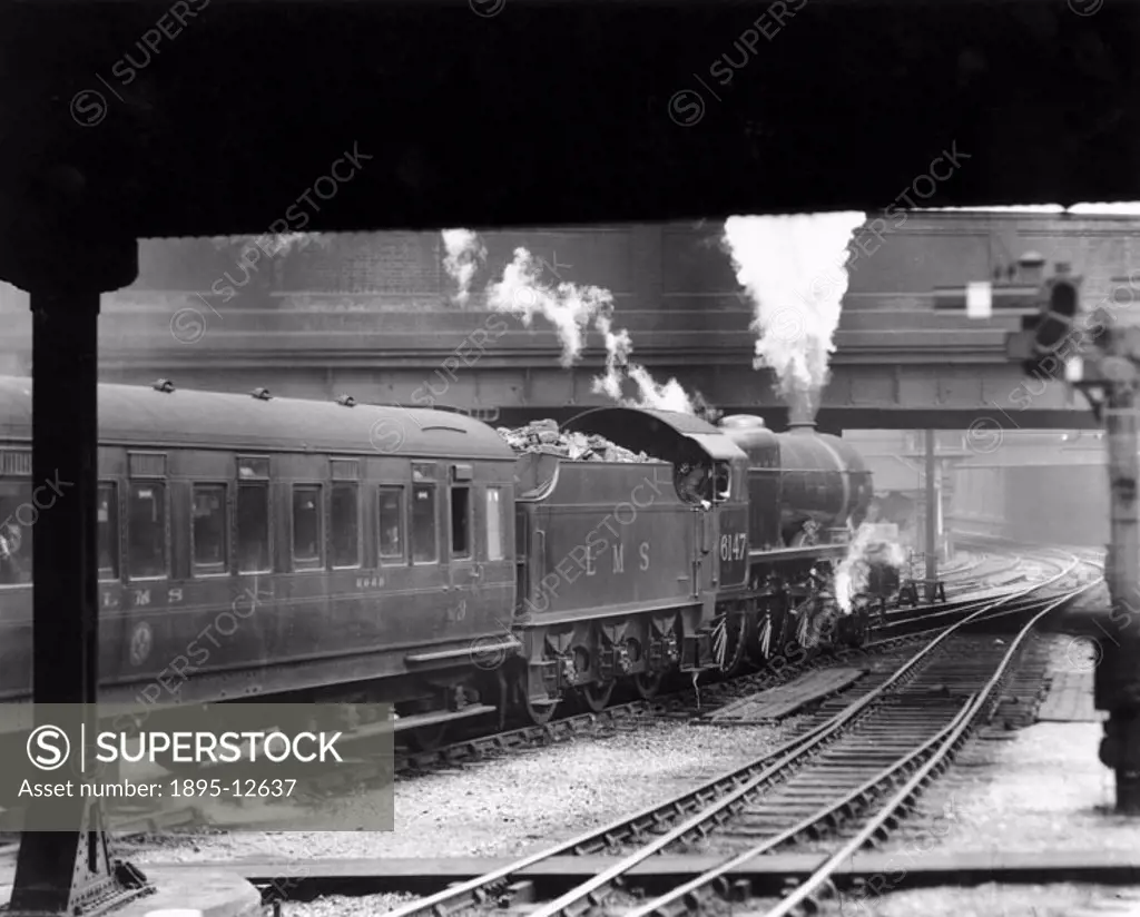 London, Midland & Scottish Railway engine, No. 6147 ´Courier´ (later ´The Northamptonshire Regiment´) leaving Euston Station with a passenger train. T...