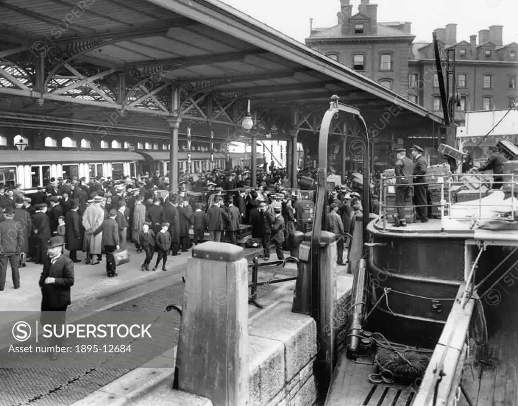 Passengers disembark from the SS ´Cedric´, arriving at the London & North Western Railway´s Holyhead docks, ready to join a waiting boat train. The cr...