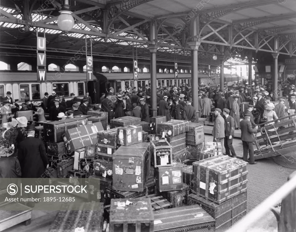 Passengers disembark from the SS ´Cedric´, arriving at the London & North Western Railway´s Holyhead docks, ready to join a waiting boat train. The cr...