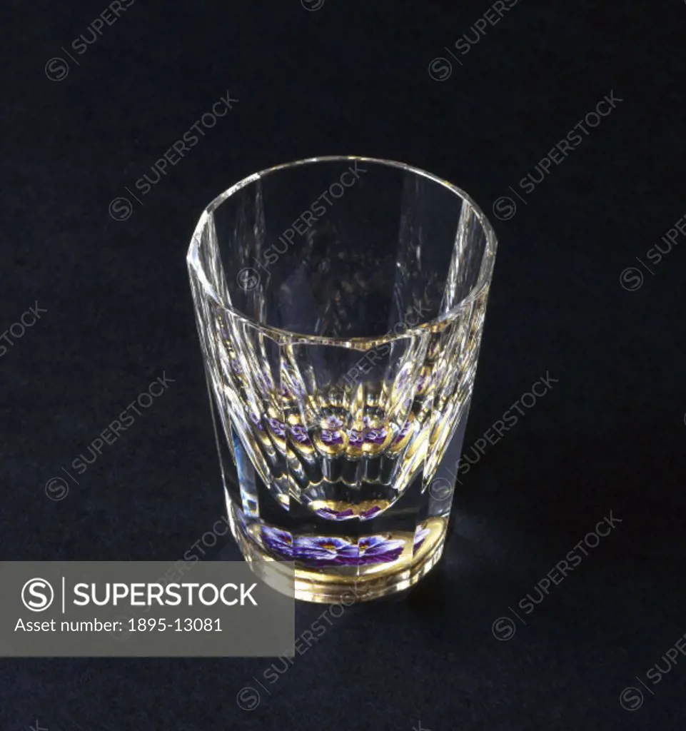 A multiplying glass is a faceted lens that shows numerous reflected copies of the image being observed. In this example, a crystal glass beaker is cut...