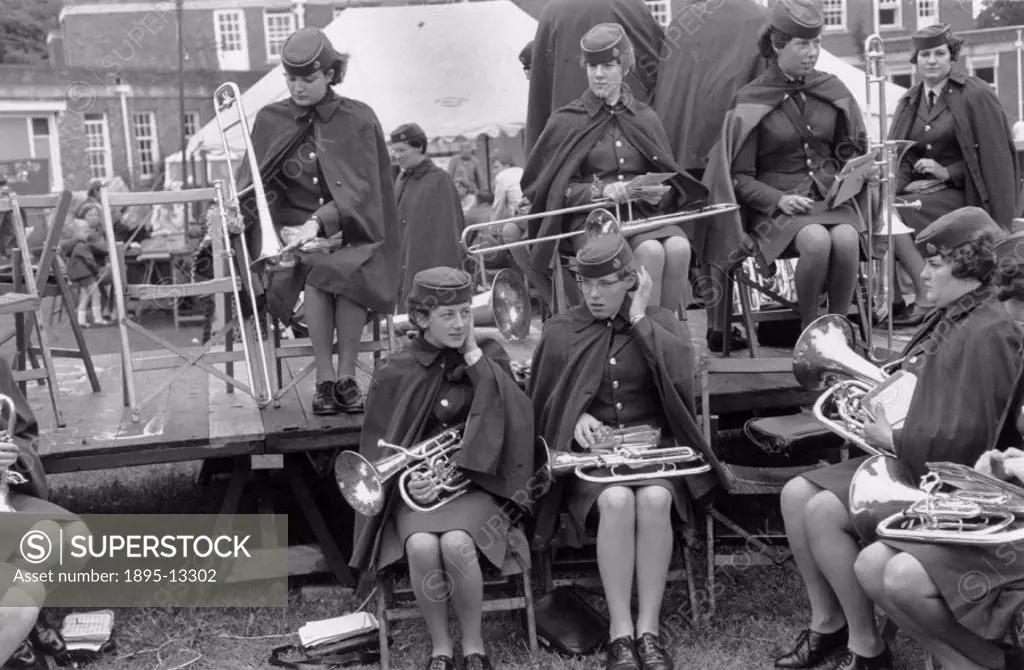 Band of women musicians in uniform, preparing to play at a festival, 1969. Taken at Weston-Super-Mare, Somerset. Photographer Tony Ray-Jones (1941-197...
