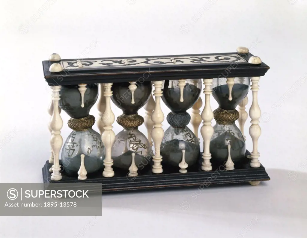 This set of sand glasses in an ornate mount of ebony and ivory is probably Italian. The glasses are marked 1/4, 2/4, 3/4, and 4/4 with time intervals ...